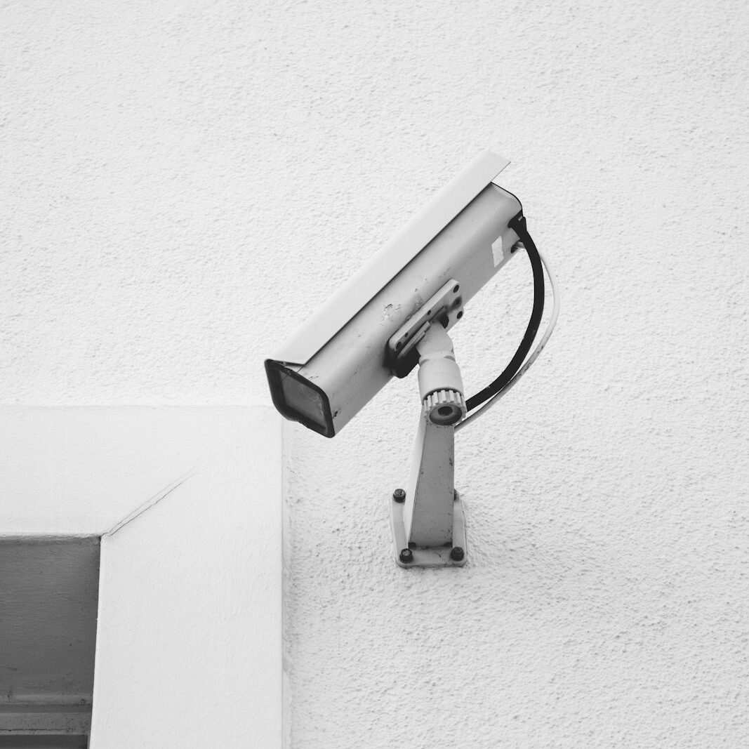 white security camera on white wall